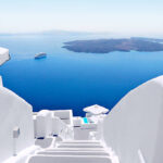 White wash staircases on Santorini Island, Greece. The view toward Caldera sea with cruise ship awaiting.